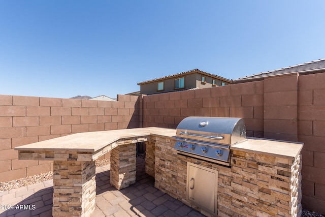 view of patio / terrace featuring an outdoor kitchen and area for grilling