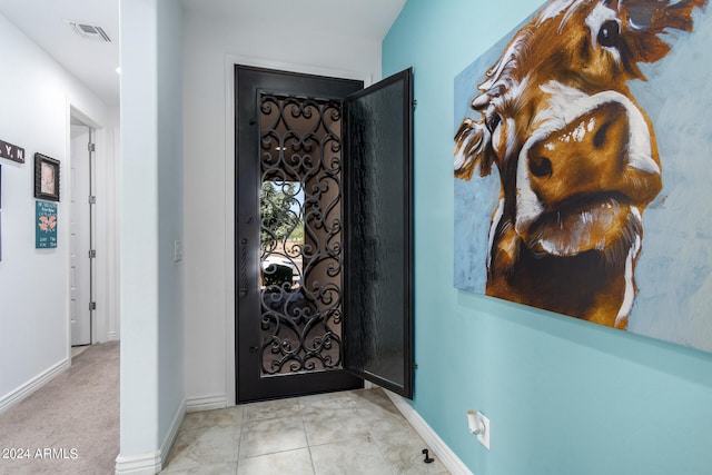 entryway with light tile patterned flooring