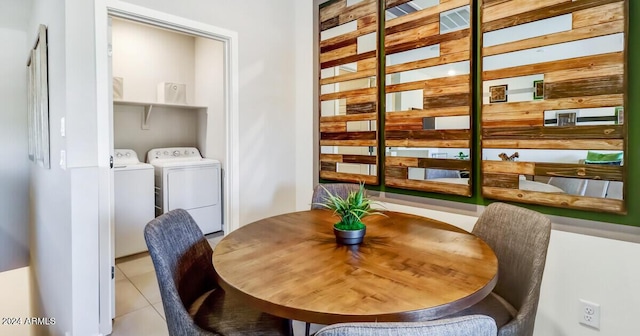 tiled dining room with washing machine and clothes dryer