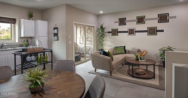 tiled living room featuring sink