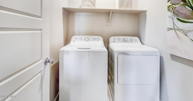 clothes washing area featuring washer and clothes dryer