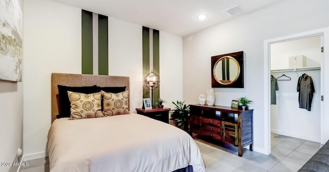 bedroom with light tile patterned floors and a closet