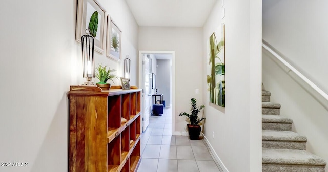 hallway with light tile patterned floors and plenty of natural light