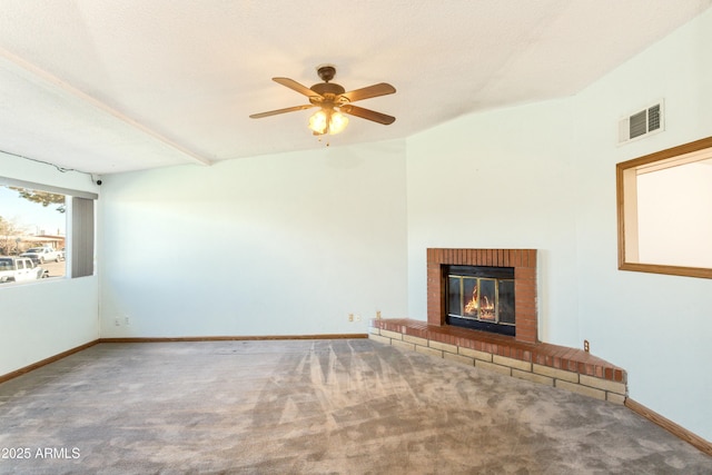 unfurnished living room with ceiling fan, carpet flooring, and a fireplace