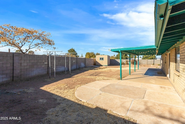 view of yard with a storage shed and a patio