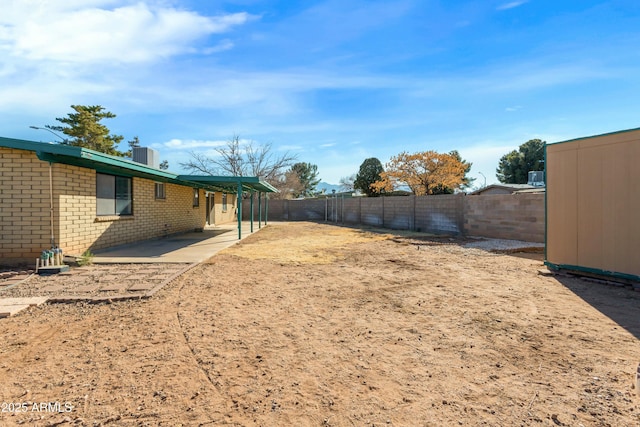 view of yard with a patio and central air condition unit