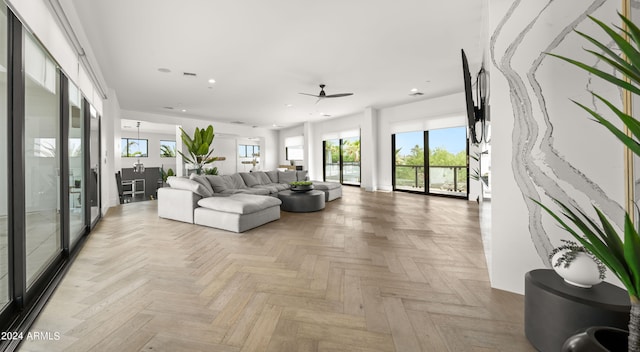 living room featuring ceiling fan and light parquet flooring