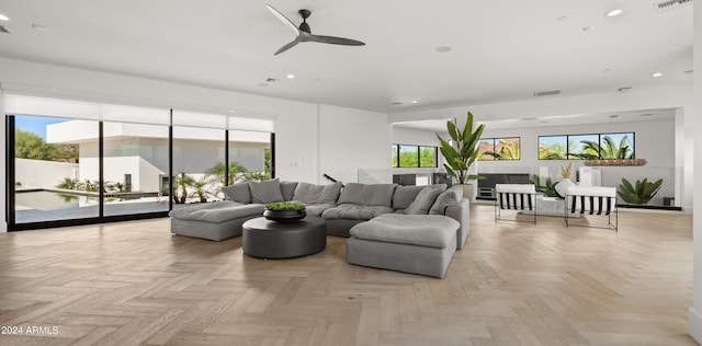 living room featuring ceiling fan and light parquet flooring