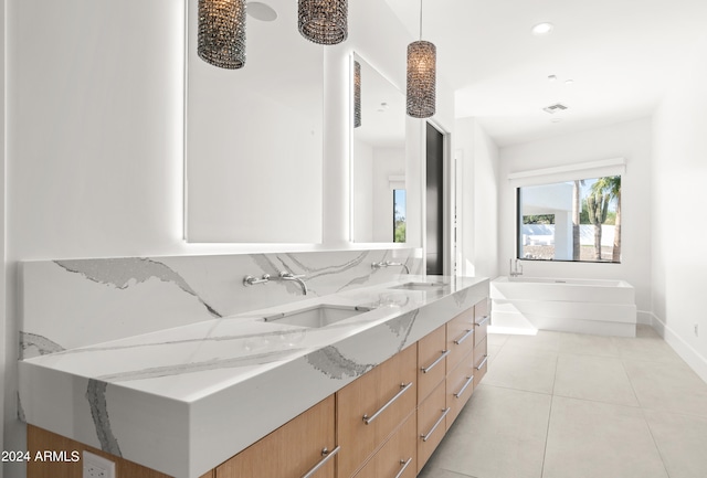 bathroom featuring dual vanity, a washtub, and tile floors