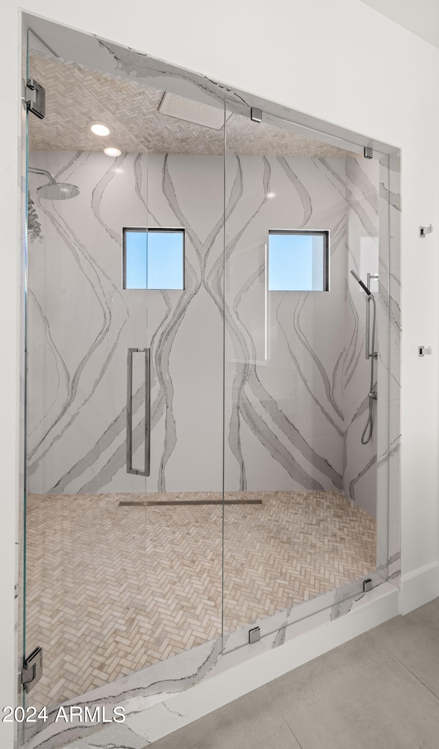 bathroom with a shower with door