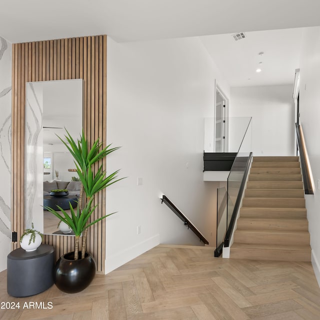 stairway featuring light parquet flooring