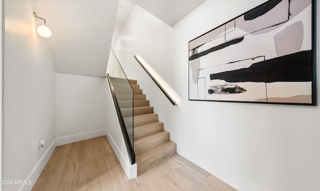 stairs with light hardwood / wood-style flooring