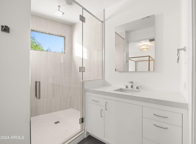 bathroom featuring walk in shower and vanity