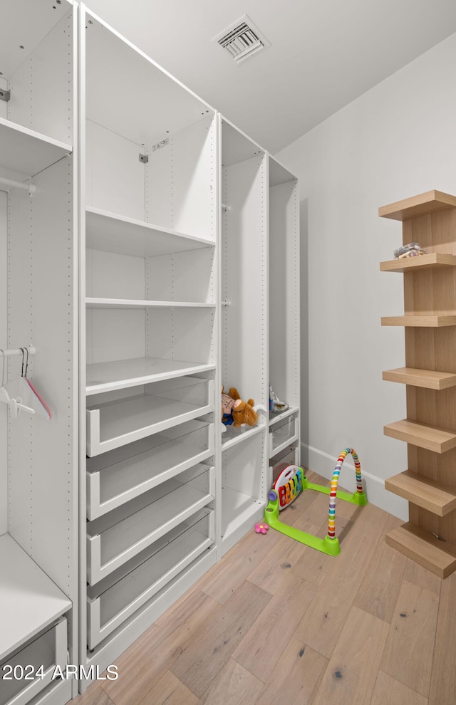 spacious closet featuring light wood-type flooring