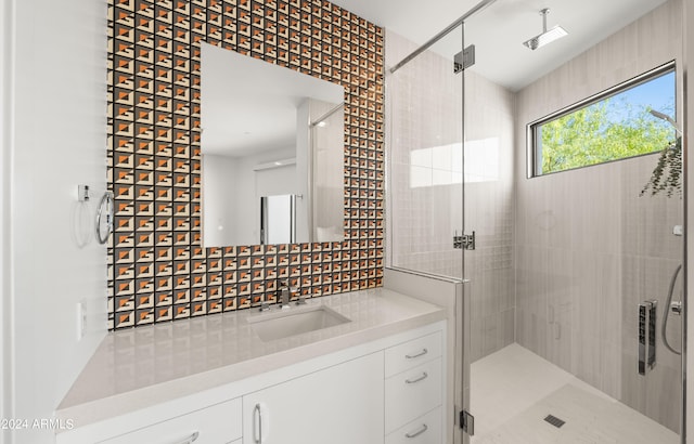 bathroom featuring an enclosed shower and vanity