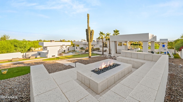 exterior space with a patio area and an outdoor fire pit