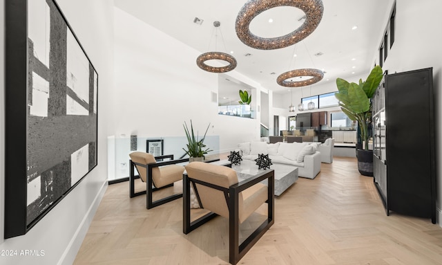 living room featuring a high ceiling and light parquet flooring