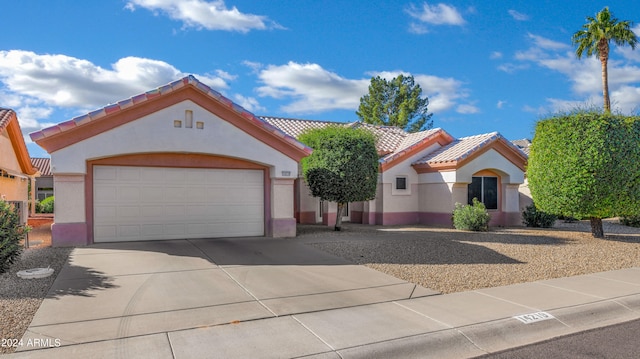 mediterranean / spanish house with a garage