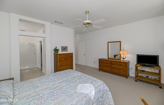 bedroom with connected bathroom, ceiling fan, and light colored carpet