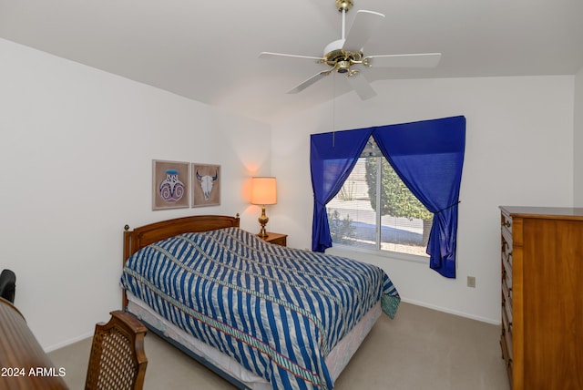 carpeted bedroom with ceiling fan and lofted ceiling