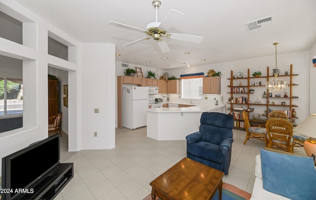 living room featuring light tile patterned floors and ceiling fan with notable chandelier