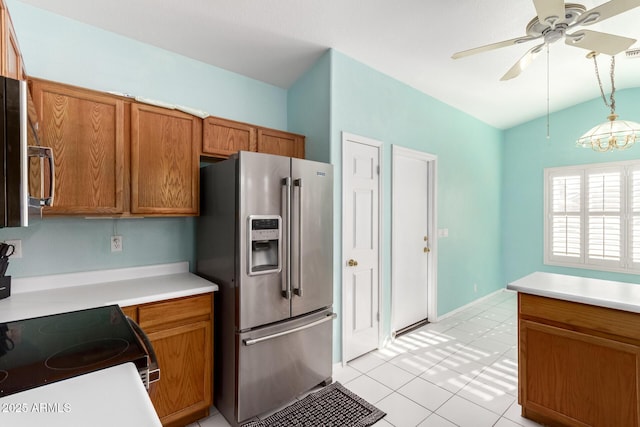 kitchen featuring stainless steel refrigerator with ice dispenser, vaulted ceiling, electric range, pendant lighting, and ceiling fan