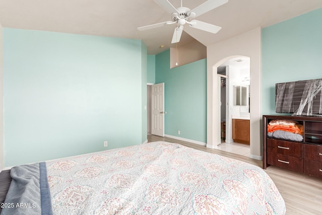 bedroom featuring ensuite bath and light hardwood / wood-style floors