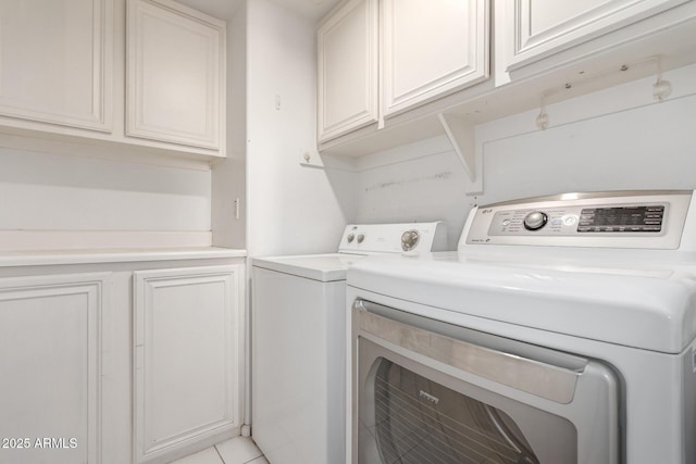 laundry area with cabinets and separate washer and dryer