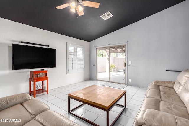 tiled living room with ceiling fan and vaulted ceiling