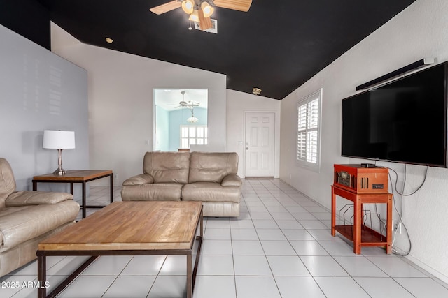 tiled living room with ceiling fan, a healthy amount of sunlight, and vaulted ceiling