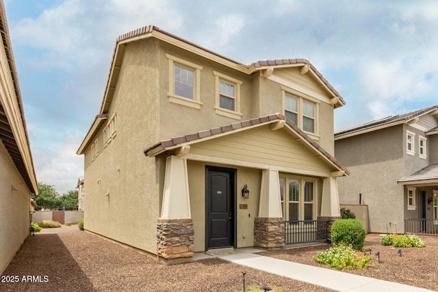 13380 N 148th Ave, Surprise, AZ 85379 - view of front facade featuring a tile roof, stone siding, stucco siding, and fence