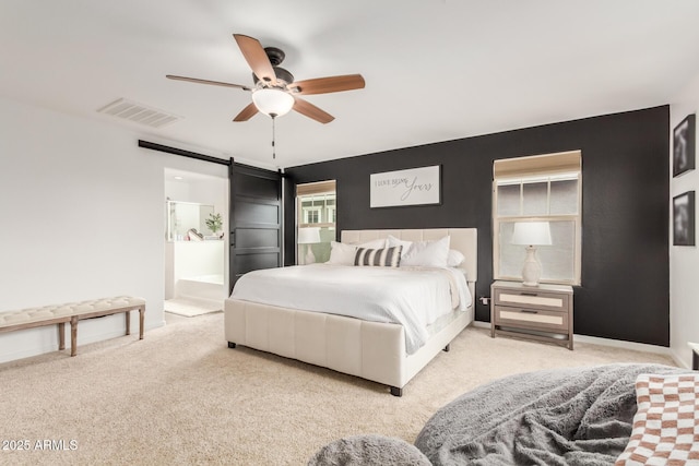 13380 N 148th Ave, Surprise, AZ 85379 - carpeted bedroom featuring a barn door, a ceiling fan, baseboards, and connected bathroom