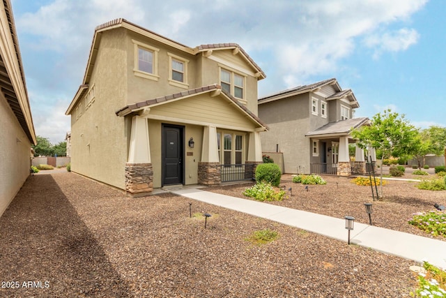 13380 N 148th Ave, Surprise, AZ 85379 - view of front of home featuring stucco siding, stone siding, a tile roof, and covered porch