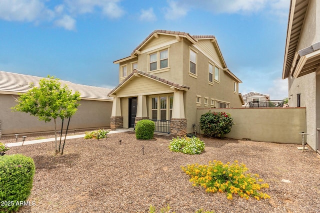 13380 N 148th Ave, Surprise, AZ 85379 - view of front facade featuring a tiled roof, fence, stone siding, and stucco siding