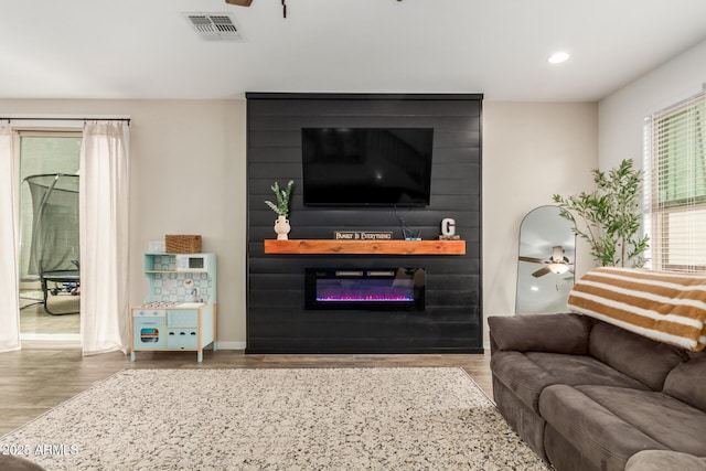 13380 N 148th Ave, Surprise, AZ 85379 - living room featuring a ceiling fan, a large fireplace, wood finished floors, recessed lighting, and baseboards