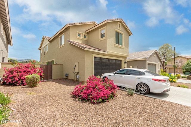13380 N 148th Ave, Surprise, AZ 85379 - view of front facade with stucco siding, an attached garage, fence, driveway, and a tile roof