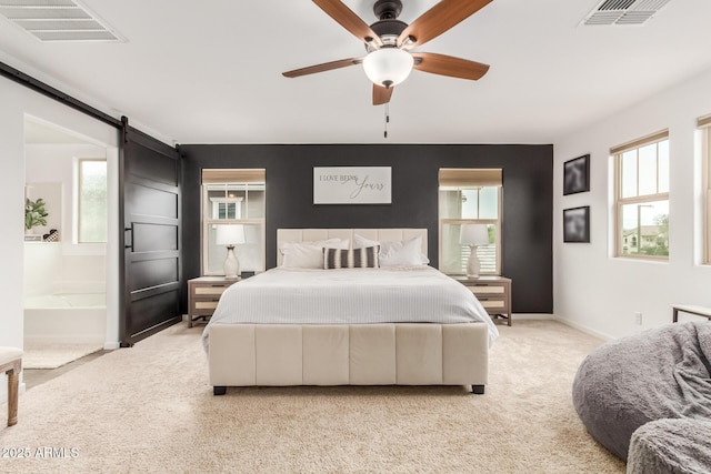13380 N 148th Ave, Surprise, AZ 85379 - carpeted bedroom with multiple windows, baseboards, a barn door, and connected bathroom