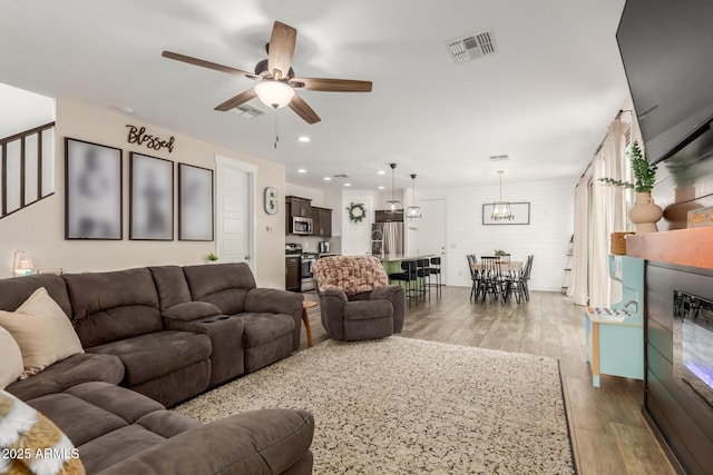 13380 N 148th Ave, Surprise, AZ 85379 - living room featuring ceiling fan, wood finished floors, recessed lighting, and a chandelier