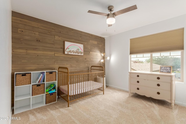 13380 N 148th Ave, Surprise, AZ 85379 - bedroom featuring carpet flooring, wood walls, a nursery area, baseboards, and a ceiling fan