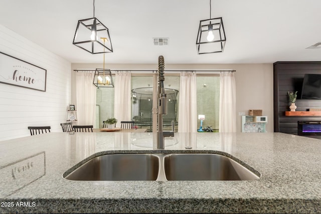 13380 N 148th Ave, Surprise, AZ 85379 - kitchen with a sink, stone counters, and hanging light fixtures