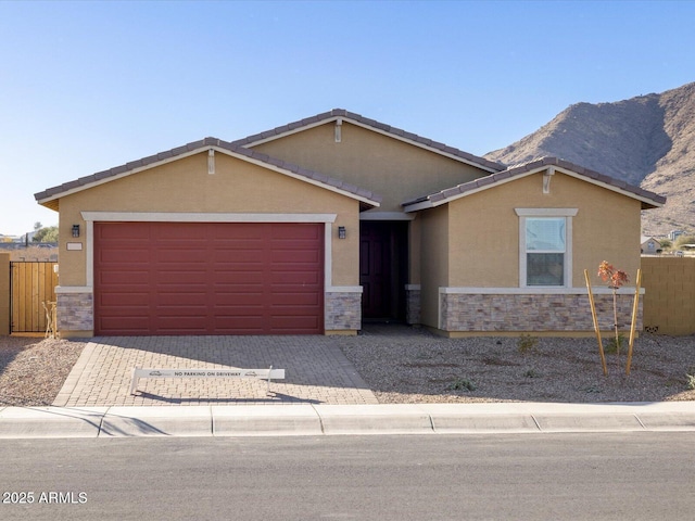 single story home featuring a garage and a mountain view