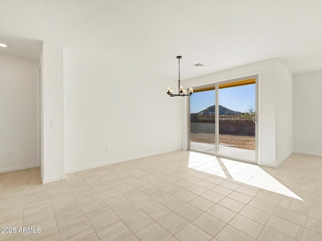 spare room featuring light tile patterned flooring and an inviting chandelier