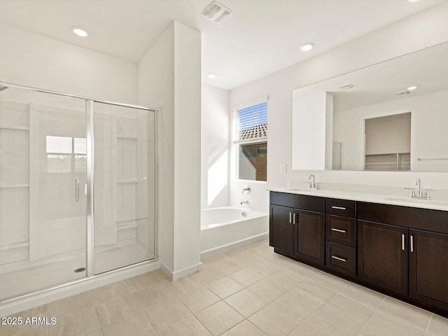 bathroom with vanity, tile patterned flooring, and shower with separate bathtub