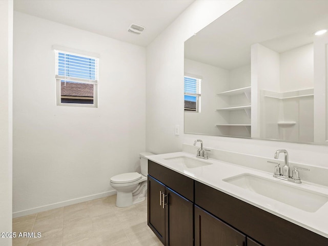 bathroom with vanity, plenty of natural light, and toilet