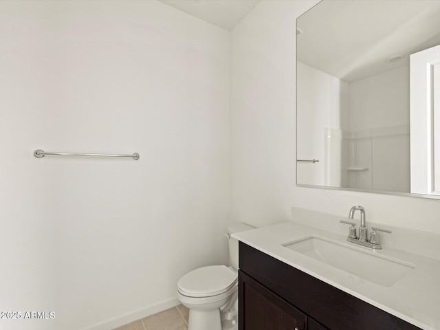 bathroom featuring tile patterned flooring, vanity, and toilet