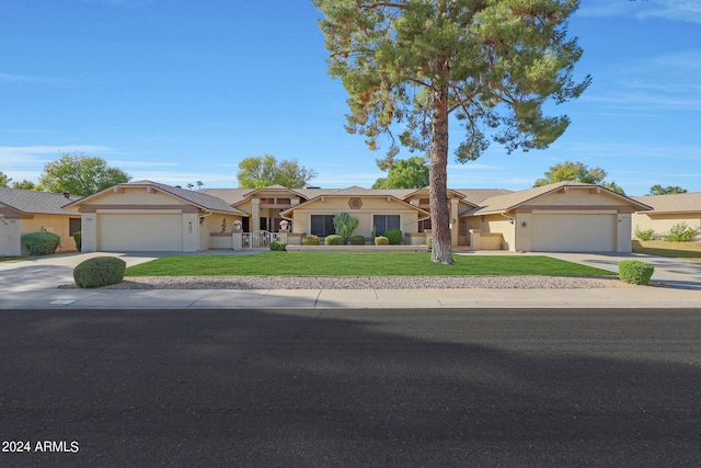 ranch-style house with a garage and a front lawn