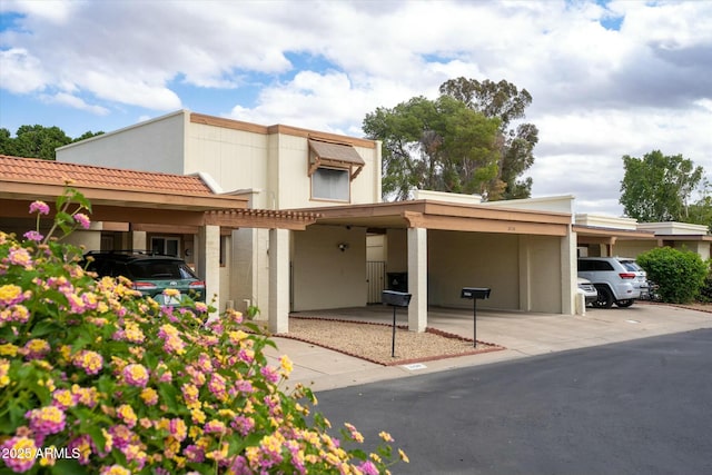 view of front facade featuring a carport and stucco siding