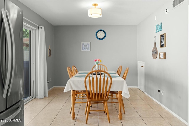 dining space featuring light tile patterned flooring, baseboards, and visible vents
