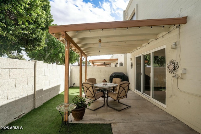 view of patio with a fenced backyard and outdoor dining space