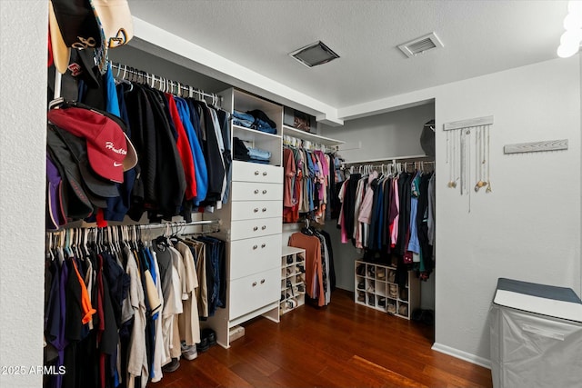 walk in closet with visible vents and wood finished floors